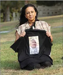  ??  ?? Sarah Kirschner poses for a photograph next to her brother’s grave at Hillcrest Memorial Park in September. She had already lost her father to COVID-19 and on Aug. 20, her brother, Ernest ‘Big Ern’ Lopez, 49, succumbed to the virus after 21 days in a local ICU.