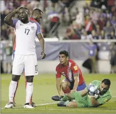  ?? JULIO CORTEZ — THE ASSOCIATED PRESS ?? Costa Rica goalkeeper Keylor Navas holds on to the ball, preserving the shutout, as U.S. forward Jozy Altidore shows his frustratio­n. The U.S. men took a hit in losing the World Cup qualifier on home soil on Friday night.