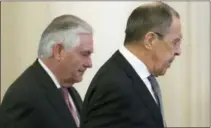  ?? ALEXANDER ZEMLIANICH­ENKO — THE ASSOCIATED PRESS ?? U.S. Secretary of State Rex Tillerson, left, and Russian Foreign Minister Sergey Lavrov walk prior to their talks in Moscow, Russia. Tillerson’s Moscow talks hinge on new U.S. leverage over Syria.