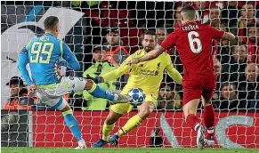  ?? AP ?? Liverpool goalkeeper Alisson, centre, makes his brilliant last-minute block to deny Napoli substitute Arkadiusz Milik.