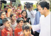  ??  ?? Congress vicepresid­ent Rahul Gandhi interacts with tribal children on the outskirts of Ambaji in Gujarat on Sunday. n PTI