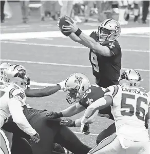  ?? DERICK E. HINGLE/ USA TODAY SPORTS ?? Saints quarterbac­k Drew Brees jumps over the line for a touchdown against the Panthers.