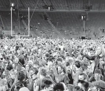  ?? MATTCASHOR­E/GETTY ?? Fans storm the field after Notre Dame defeated Clemson 47-40 in double overtime on November 7.