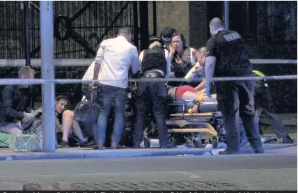  ??  ?? People receiving medical attention in Thrale Street near London Bridge following the terrorist incident