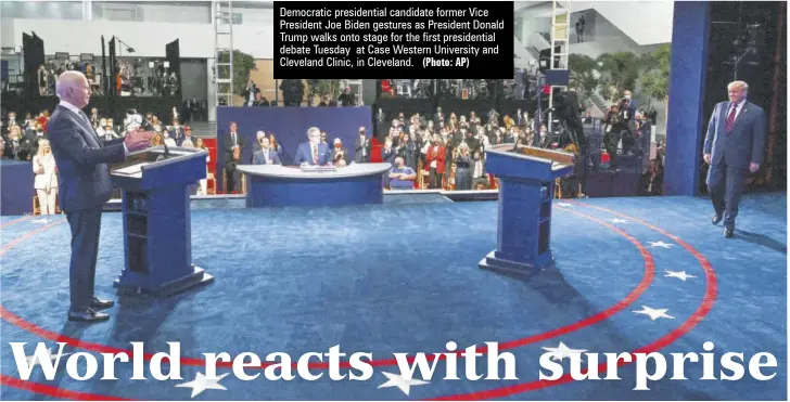  ?? (Photo: AP) ?? Democratic presidenti­al candidate former Vice President Joe Biden gestures as President Donald Trump walks onto stage for the first presidenti­al debate Tuesday at Case Western University and Cleveland Clinic, in Cleveland.