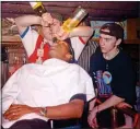  ??  ?? PARTY: Paul Ince has bottles of booze poured into him in 1996