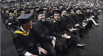  ?? ?? New England Institute of Technology graduates, including Lucas Sutton, center, take their seats.