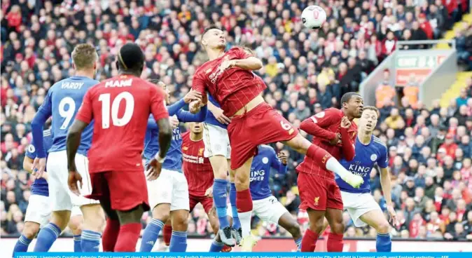  ??  ?? LIVERPOOL: Liverpool’s Croatian defender Dejan Lovren (C) rises for the ball during the English Premier League football match between Liverpool and Leicester City at Anfield in Liverpool, north west England yesterday.