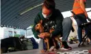  ?? Photograph: Juan Medina/Reuters ?? A woman brings an abandoned dog she found to an animal rescue centre.