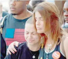  ?? — AFP ?? Anti-gun violence advocate and Marjory Stoneman Douglas High School shooting survivor Emma Gonzales (C) is comforted at the “End of School Year Peace March and Rally” in Chicago on Friday.