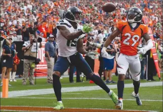  ?? The Associated Press ?? Seattle Seahawks receiver Brandon Marshall, left, hauls in a touchdown pass in the end zone as Denver Broncos defensive back Bradley Roby looks on during NFL action this past Sunday in Denver.The Seahawks will look for a better result in Chicago against the Bears for the Monday nighter in Week 2.