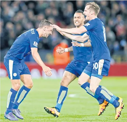  ??  ?? Leicester’s Danny Drinkwater, left, celebrates with teammates after scoring against West Bromwich.