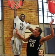  ?? THOMAS NASH - DIGITAL FIRST MEDIA ?? The Hill School’s Chase Audige (15) rises up for a dunk over Kiski School’s Jaka Pandza (10) during the first half of Friday’s game.