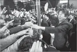  ?? KIMIMASA MAYAMA/EPA-EFE ?? Japanese Prime Minister Shinzo Abe greets potential voters Saturday in Tokyo.