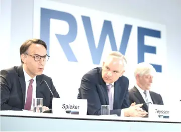  ??  ?? EON CFO Marc Spieker, from left, EON CEO Johannes Teyssen, RWE ECO Rolf Schmitz and RWE CFO Markus Krebber during a news conference in Essen, Germany on Tuesday.