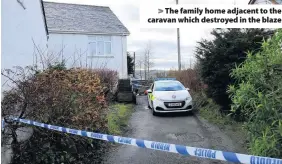  ??  ?? > The family home adjacent to the caravan which destroyed in the blaze