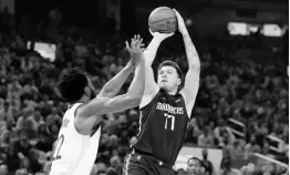  ?? AP ?? Dallas Mavericks guard Luka Doncic (77) shoots against Golden State Warriors forward Andrew Wiggins during the first half of Game Two of the NBA basketball playoffs Western Conference finals in San Francisco on Friday, May 20.