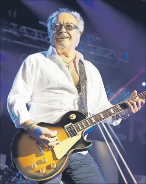  ?? AP PHOTO ?? Mick Jones of the band Foreigner performs during the Soundtrack of Summer Tour 2014 in Camden, N.J. Many of the rock ’n’ roll bands that were huge in 1977 will comprise a big part of the summer concert market 40 years later. Foreigner is among those...