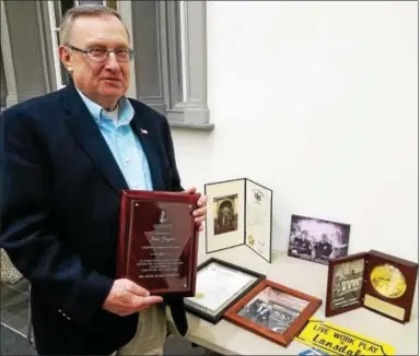  ?? DAN SOKIL — DIGITAL FIRST MEDIA ?? Jake Ziegler, recently retired as borough manager, poses with gifts and proclamati­ons presented to him by former Lansdale Borough colleagues during council’s Jan. 17 meeting.