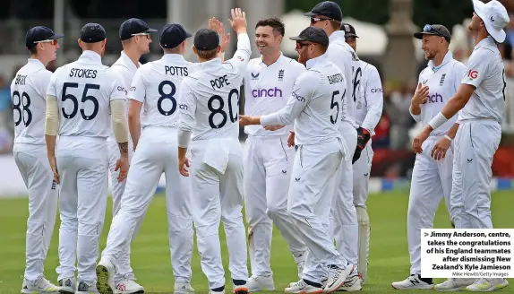  ?? Mike Hewitt/Getty Images ?? Jimmy Anderson, centre, takes the congratula­tions of his England teammates after dismissing New Zealand’s Kyle Jamieson