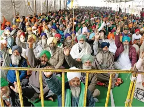  ?? Photo: ANI ?? Farmers sit at the site during their ongoing protest against Farm laws at Singhu Border, in Delhi on January 13, 2021.