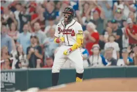  ?? AP PHOTO/JOHN BAZEMORE ?? Atlanta Braves' Ronald Acuna Jr. celebrates Wednesday after driving in a run with a single during the game against the New York Mets in Atlanta.