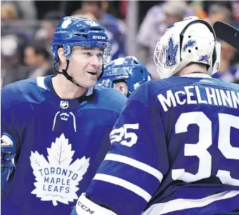  ?? FRANK GUNN/THE CANADIAN PRESS ?? Toronto Maple Leafs centre Patrick Marleau congratula­tes backup goalie Curtis McElhinney on his 41-save, 1-0 shutout win over the Edmonton Oilers on Sunday in Toronto.