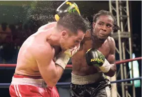  ?? FILE ?? Jamaica’s Richard Holmes (right) in action against Canada’s Frank Cotroni last year.