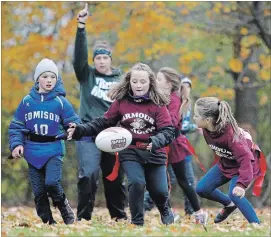  ?? CLIFFORD SKARSTEDT EXAMINER ?? Edmison Heights and Armour Heights players compete during Flag Rugby, Kawartha Pine Ridge Elementary Athletic Associatio­n North Intermedia­te Tournament action on Wednesday at Beavermead Park.