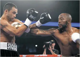  ?? PHOTO BY MIKE WILLIAMS ?? Waldorf resident Mike “Yes Indeed” Reed lands a right punch against Sidney Sequeira in their recent bout at the CenturyLin­k Center in Omaha, Neb. Reed won an eight-round unanimous decision to keep his pro boxing record perfect at 21-0-0.