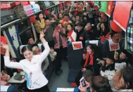  ?? ZHU LIXIN / CHINA DAILY ?? Government employees from Fuyang, Anhui province, provide entertainm­ent on a train on Feb 7 informing passengers about the latest developmen­ts in the city.