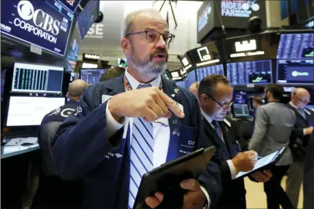  ?? RICHARD DREW — THE ASSOCIATED PRESS ?? Trader David O’Day works on the floor of the New York Stock Exchange, Monday. Technology stocks were leading indexes higher on Wall Street after the U.S. gave Chinese telecom giant Huawei another 90 days to buy equipment from American suppliers.