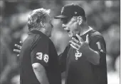  ??  ?? San Francisco Giants manager Bruce Bochy rgues with home plate umpire Gary Cederstrom after he ejected Bochy during the seventh inning of Friday’s game against the Colorado Rockies in Denver. The Rockies won, 10-8.