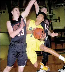  ?? PHOTO BY RICK PECK ?? McDonald County’s Cooper Reece (13) and Dagan Stites (10) defend Diego Bernard of St. Joseph Lafayette in the opening game of the Neosho Holiday Classic. The Irish won the game.