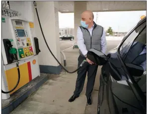  ?? (AP) ?? A man pumps gasoline last month at a Shell gas station in Westwood, Mass. U.S. consumer prices in February saw their biggest increase in six months, the Labor Department said Wednesday.