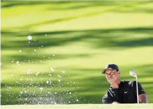  ?? JAMIE SQUIRE GETTY IMAGES ?? Tiger Woods plays a shot from a bunker on the second hole at Augusta National in the second round of the Masters golf tournament in Augusta, Ga., on Friday.