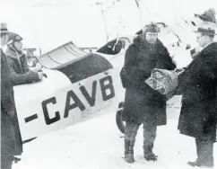  ??  ?? Bush pilot Wilfrid “Wop” May receives diphtheria medication from Alberta’s deputy health minister Dr. Malcolm Bow for his daring 1929 mercy mission to stem an outbreak in Fort Vermilion.