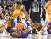  ?? Alan Youngblood Associated Press ?? TENNESSEE’S Jahmai Mashack, top, trips up Florida’s Alex Fudge in the first half of the Gators’ win.