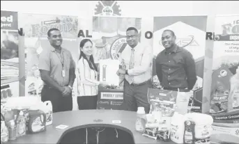  ?? ?? SPL Business Developmen­t and Quality Assurance Manager Anthony Ross receives the Made in Guyana Certificat­e from GNBS Technical Officer Yan Yi Zhu