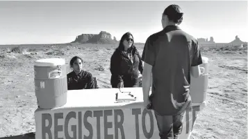  ?? Tribune News Service ?? ■ Delaney After Buffalo, left, and Tara Benally register Shaye Holiday to vote in Monument Valley, Utah. Native Americans here have a chance to take control of local government for the first time.