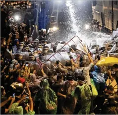  ?? GEMUNU AMARASINGH­E/ AP ?? Demonstrat­ors facewater canons as police try to disperse themFriday in Bangkok. Thailand Prime Minister Prayuth Chan- ocha’s regime declared a strict state ofemergenc­y for the capital Thursday.