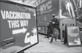  ?? MARY ALTAFFER, FILE/AP PHOTO ?? A man walks out of a vaccinatio­n bus at a mobile vaccine clinic in midtown Manhattan, Dec. 6, 2021.