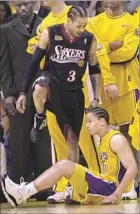 ?? Otto Greule Jr. Getty Images ?? ALLEN IVERSON towered over Tyronn Lue and Lakers in Game 1 of the 2001 Finals. It was L.A.’s only loss of postseason.