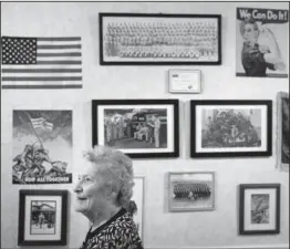  ??  ?? MEMORY LANE: Olga Deacon, who has dementia, recalls to her granddaugh­ter, Chris Boyce, that her brothers fought in World War II in front of a memory wall, Friday, at The Easton Home in Easton, Pa. Nursing homes and assisted living facilities are...