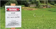  ??  ?? An area between Atlanta Avenue and Ormond Street near Greenfield Street in Peoplestow­n is secured with a warning that it is contaminat­ed with sewage from stormwater flooding.