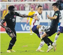  ?? THE ASSOCIATED PRESS ?? Canada’s Alphonso Davies, left, and Stephen Eustaquio battle for the ball against the United States’ Sergino Dest during their World Cup qualifier in Nashville, Tennessee.