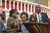  ?? PARKER MICHELS-BOYCE/THE NEW YORK TIMES ?? Caroline Ouko, in sunglasses, the mother of Irvo Otieno, becomes emotional as attorney Ben Crump speaks during a news conference this week. Otieno was subdued March 6 by sheriff’s deputies and medical staff at a state psychiatri­c hospital for roughly 11 minutes, until his death.