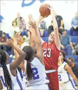  ?? Scott Herpst ?? Saddle Ridge’s Macee Casteel goes up for a shot over a pair of Rossville defenders Kiara Williams and Adasia Binford during last Tuesday’s season opener. Casteel had a team-high 18 points in a 44-20 win.