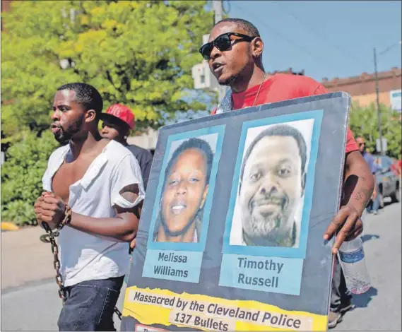  ??  ?? Protesting: African-Americans demonstrat­ed when a Cleveland police officer was acquitted of manslaught­er after he shot Melissa Williams and Timothy Russell in 2012 following a high-speed car chase. Photo: Ricky Rhodes/Getty Images/AFP