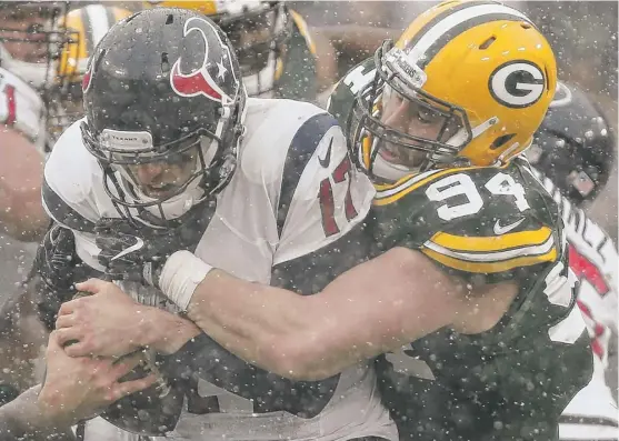  ?? | MIKE ROEMER/ AP ?? Rookie defensive end Dean Lowry sacks the Texans’ Brock Osweiler in the first half. The Packers are 6- 6 and trail the Lions by two games in the NFC North.